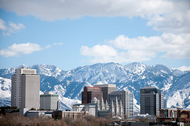 Salt Lake City Utah Winter Skyline With Snow Covered Mountains Winter daytime shot of Salt Lake City.  Featured is the temple from the Church of Jesus Christ of Latter Day Saints or the Mormons salt lake city utah stock pictures, royalty-free photos & images