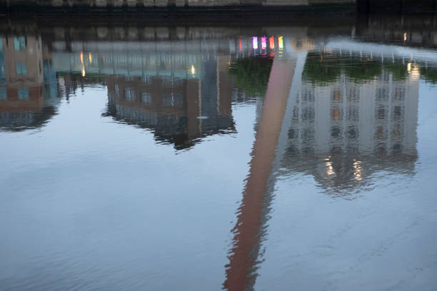 istock City buildings reflected in a river at dusk 1607369006
