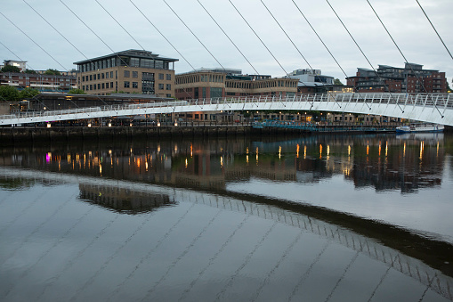 The Gateshead Millennium Bridge reflected in the water