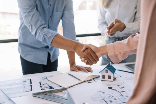 istock Architect and engineer work together and shaking hands to welcome home design projects to work in the same way and work together as a team. 1607370660