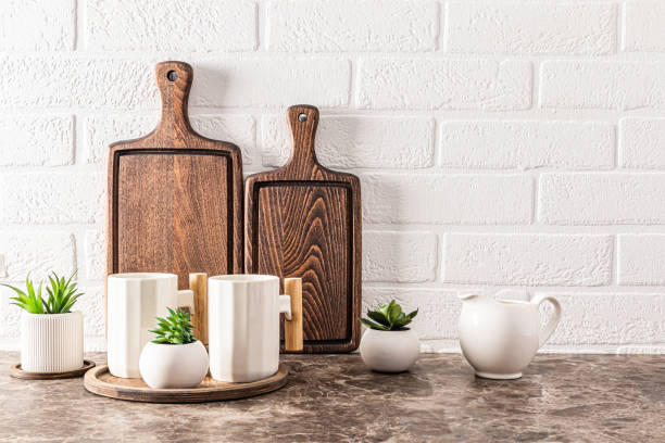 istock Stylish kitchen backdrop with dark wooden cutting boards and beautiful modern mugs. front view. Eco items. 1607376626