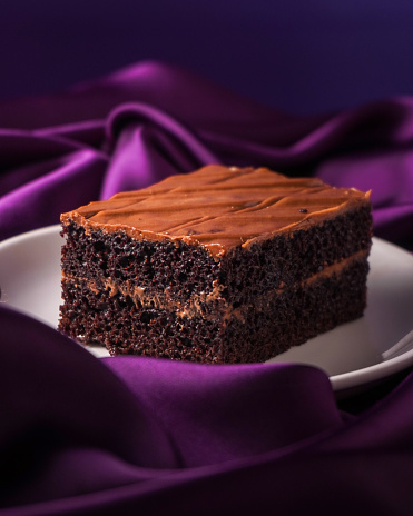 Swiss dark chocolate cake pastry on the purple background