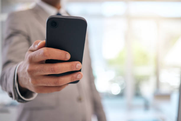 istock Hands, business man and typing with phone for social network information, mobile internet and search website. Closeup, office worker and smartphone to contact, digital news app and technology space 1607435114