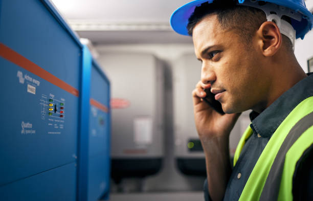 phone call, man and technician working in control room or engineering service on switchboard, power box or maintenance on generator. electrician, construction worker and check on inverter and advice - customer service representative service switchboard operator operator imagens e fotografias de stock
