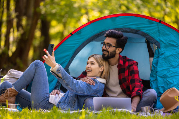 istock Young couple spending time in nature in the forest and looking relaxed and happy 1607476607