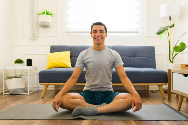 istock Caucasian man doing yoga using a mock-up t-shirt 1607480501