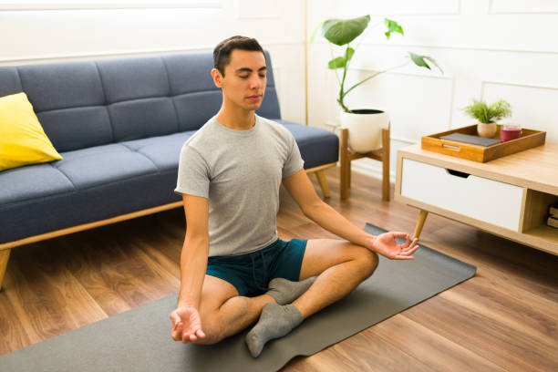 istock Young man relaxing while wearing a gray t-shirt with copy space 1607481019