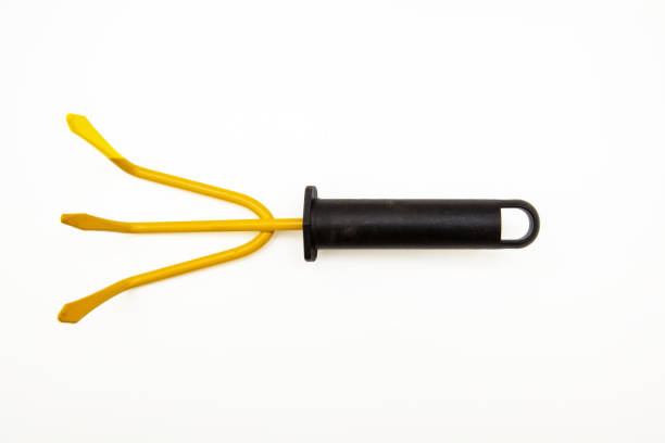 Garden rake yellow color isolated on white background, view from above,