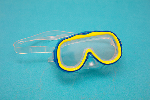 Diving mask snorkel equipment isolated on blue background.