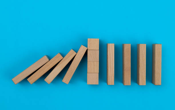 istock Wooden blocks stop other falling dominos 1607506654