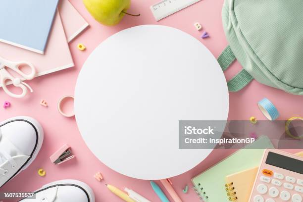 Stylish Girly School Equipment Scene Top View Of Stationery Bag Pens Ruler Adhesive Tape Scissors Diaries Alphabet Letters And More On Pastel Pink Background Empty Circle For Text Or Ad Stock Photo - Download Image Now