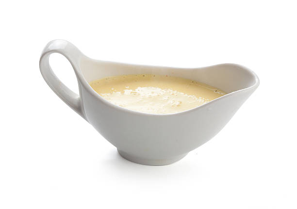istock Cheese sauce in a gravy boat isolated on white 160754243