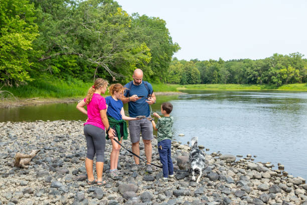 Family on Bank of Mississippi River in Summer stock photo