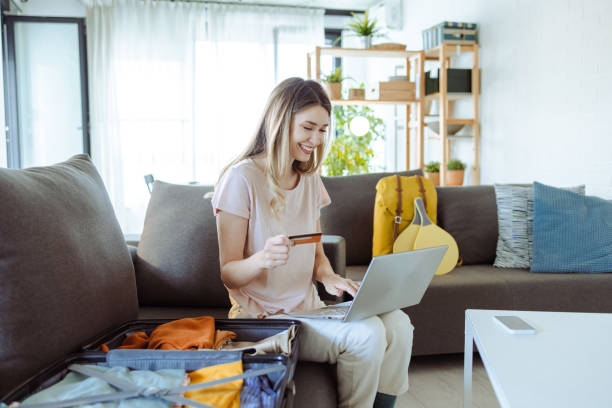 istock Young woman booking trip online 1607548620