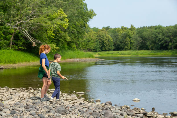 istock Brother & Sister Exploring Mississippi Riverbed in Summer 1607548677