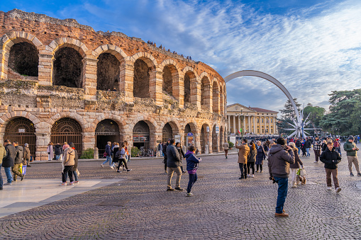 Verona, Italy - January 21 2023 - Tourists visiting the Ancient Roman Arena on Piazza Bra (Bra Square)
