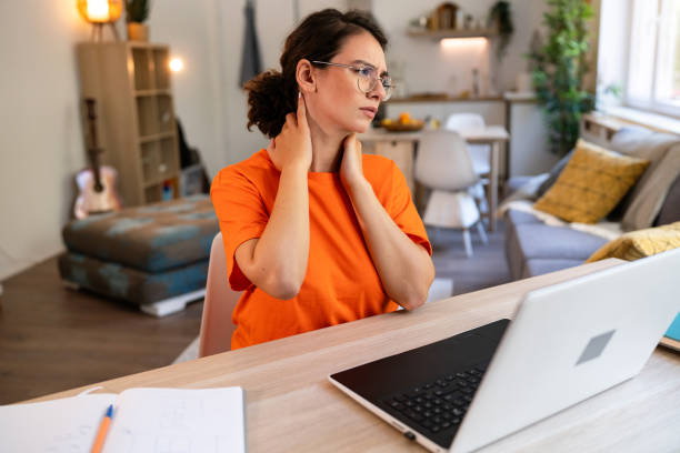 istock Young Caucasian woman experiencing neck ache, while working from home 1607564714
