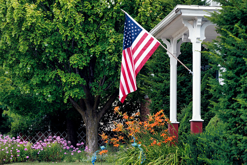 A patriotic summer scene and a beautiful front yard garden in Manitowoc, Wisconsin.