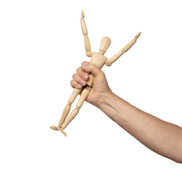 istock a small wooden dummy in a man's hand 1607621775