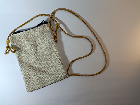 Linen fabric braided bag isolated on a white background. Cotton linen eco-friendly bag.