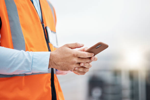 istock Phone, architecture and hands of man in city for engineering, construction site and communication. Building, social media and mobile app with closeup of contractor for contact, networking and mockup 1607631962