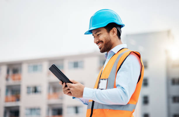 istock Construction worker, tablet and with research and digital data for building renovation outdoor. Happy, engineer and male contractor with management and builder project with tech and online plan 1607632084