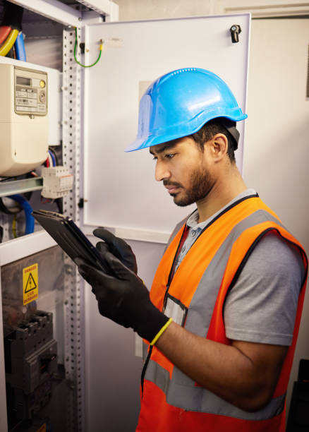 Tablet, engineering and man with electricity box for repair, maintenance and technician inspection. Industrial, electrician and male worker on digital tech for service, test or power source check