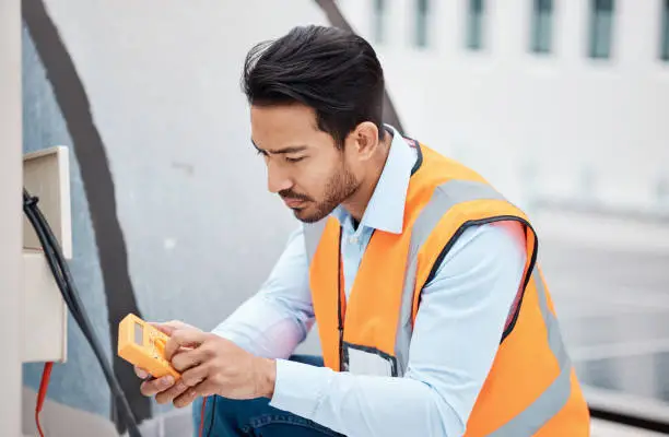 Photo of Multimeter, electricity and man with air conditioner for repair, maintenance and inspection on roof. Solar power, construction and male worker with tools for service, installation and engineering