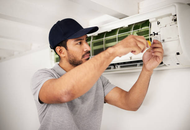 istock Maintenance, air conditioner technician and man with screwdriver working on ventilation for ac repair. Contractor, handyman or electric aircon machine expert problem solving, electrician with tools. 1607633695