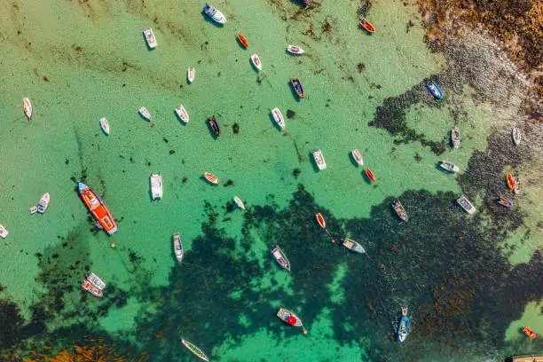 Aerial photo from a drone captured in August 2023 of a collection of moored boats at St Agnes Island, Isles of Scilly, Cornwall, UK.