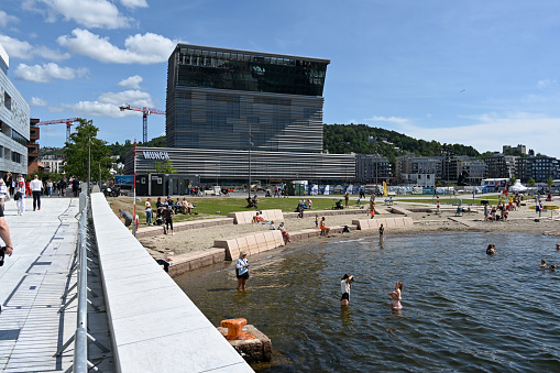 Oslo, Norway, July 5, 2023 - The Munch Museum (Munchmuseet in Norwegian) seen from Oslo Opera House.