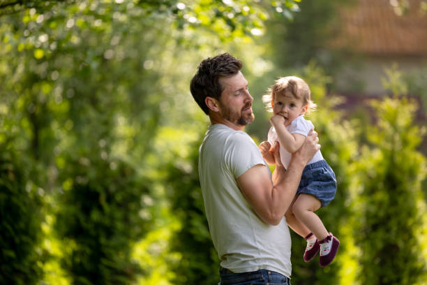 istock Happy young dad playing with his son and looking contented 1607645491