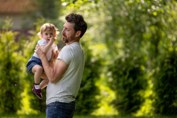 istock Happy young dad playing with his son and looking contented 1607646022