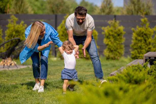 istock Young parents with a little cute boy in the park 1607646040