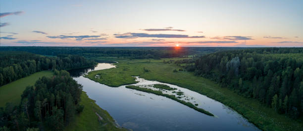 istock Aerial panoramic landscape with sunset over the river with islands and beautiful clouds on the sky. 1607654156