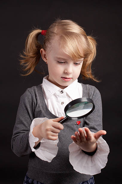 istock the curious girl with a magnifying glass 160765491