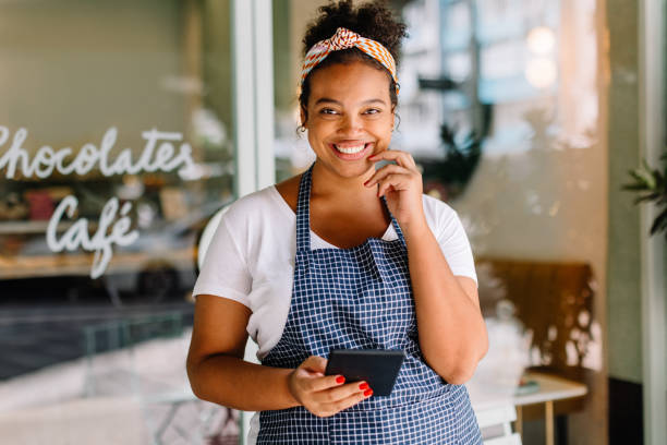 istock Young businesswoman smiling and using her tablet pc 1607667222