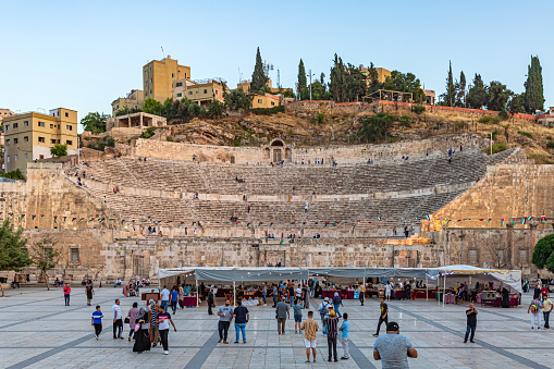 The Roman Theatre in Amman, Jordan, is a remarkable archaeological site and a testament to the city's ancient history. Constructed during the Roman era, this well-preserved amphitheater is an iconic landmark that showcases Roman architectural prowess. The theatre's semicircular seating arrangement can accommodate thousands of spectators and was used for various performances and events.\n\nThe Roman Theatre stands as a visual reminder of Amman's historical significance as a hub of culture and entertainment during ancient times. Its grandeur and historical context attract both tourists and history enthusiasts, offering a glimpse into the city's past. The site's architectural elegance and cultural value make it a must-visit destination for those interested in exploring Jordan's rich heritage.