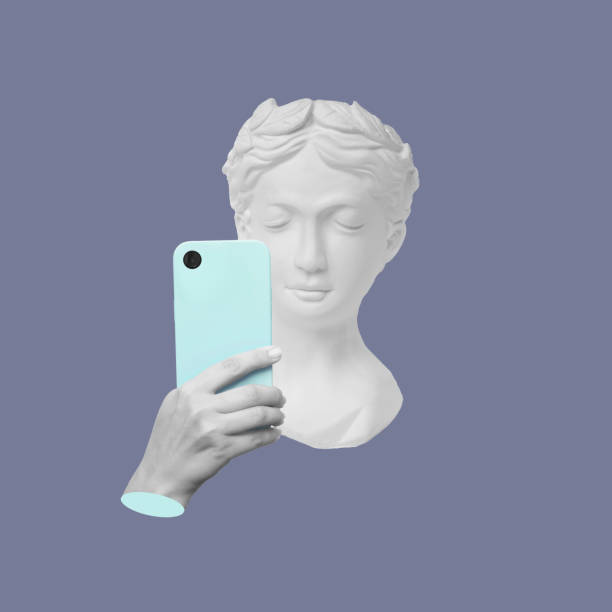 istock Antique statue head holding blue mobile phone with camera taking a picture or surfing Internet 1607677889