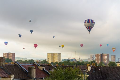 Aerial panoramic view of Oxford University, Oxfordshire, UK with cloudy weather and hot air balloons in the sky