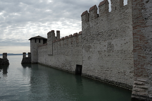 Sirmione. Italy.  06.29.2023. View of the castle of Sirmione, early morning on a cloudy day. Lake Garda , Italy