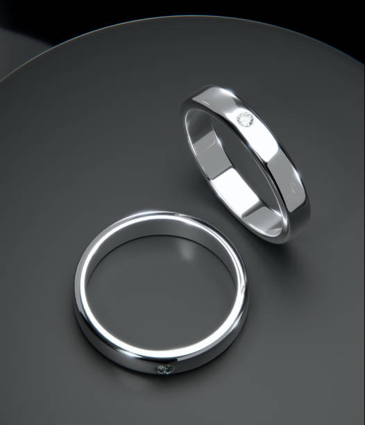 istock Top view Two platinum diamond rings in a studio scene. from design with 3D render. 1607706860