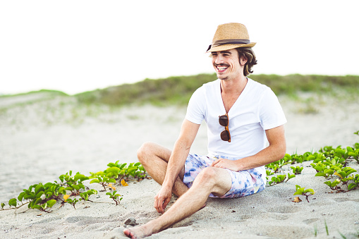 Handsome young guy hanging out at n the beach