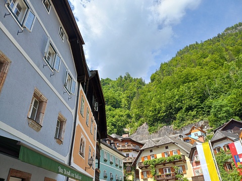 Hallstatt, Austria - June 7, 2023: \n Beautiful houses in sunny summer, on the mountainside of the Hallstatt town, Austria.