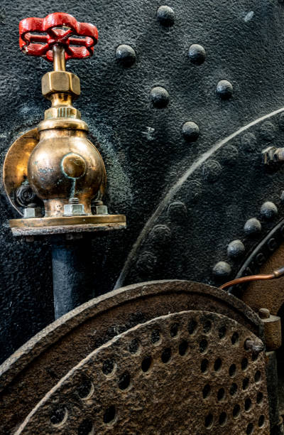 Heavy Riveted Steam Boiler & Regulator Valve At Combe Mill, Oxfordshire Heavy riveted steam boiler ( disused ) and regulator valves at Come Mill in Oxfordshire. burton sussex stock pictures, royalty-free photos & images