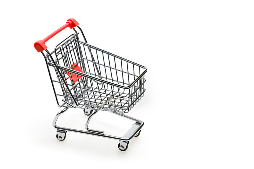 Shopping cart with red handle on white