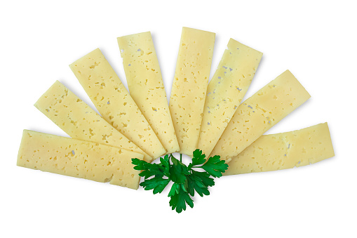 Cheese cut into thin slices, spread out in a fan, fresh parsley leaves in the center, isolated on a white background.