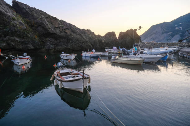 boats in the harbor of Framura, Liguria, Italy during sunset sky across cliffs boats in the harbor of Framura, Liguria, Italy during sunset sky across cliffs lavagna stock pictures, royalty-free photos & images