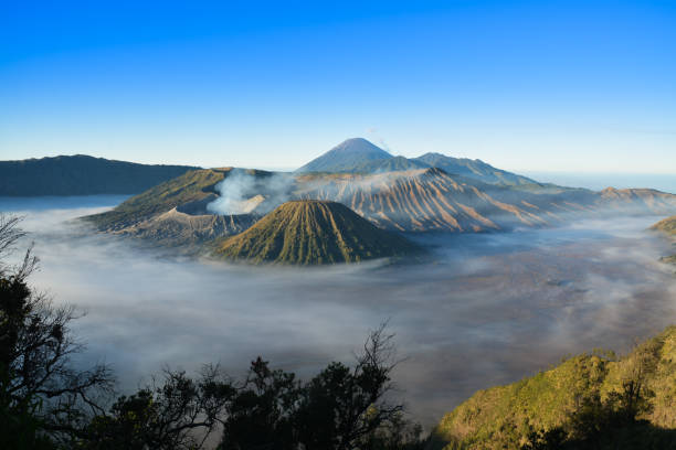 Aerial Image of Sunrise in Mt. Bromo Image of tranquil sunrise in Bromo. The Volcanic mountains formation of Mount Bromo, Mount Batok, and Mount Semeru in East Java, made this place as one of best destination in the world.  Where the sunrise moment is always captivated tourists and the most waited moment of nature attraction. jawa timur stock pictures, royalty-free photos & images