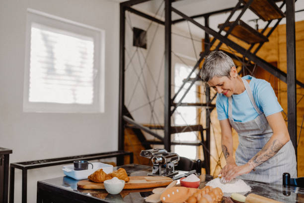 istock Woman making homemade pasta 1607812280
